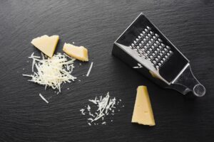 Flat lay grated parmesan with grater