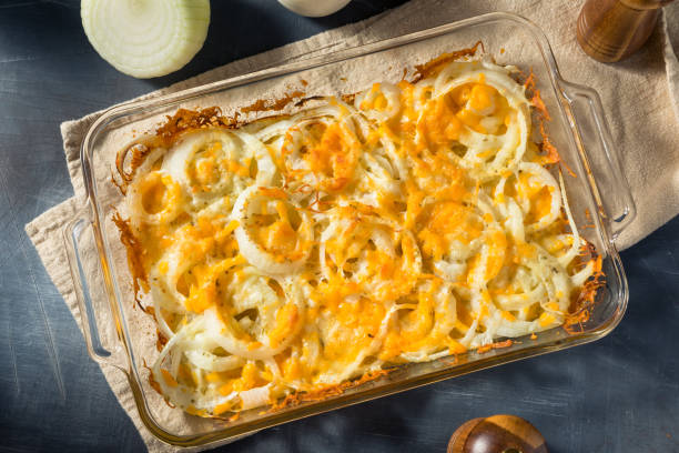 A casserole dish filled with baked Tennessee onions topped with golden, melted cheese.